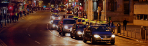 multiple Taxi in traffic in Dublin Ireland at night